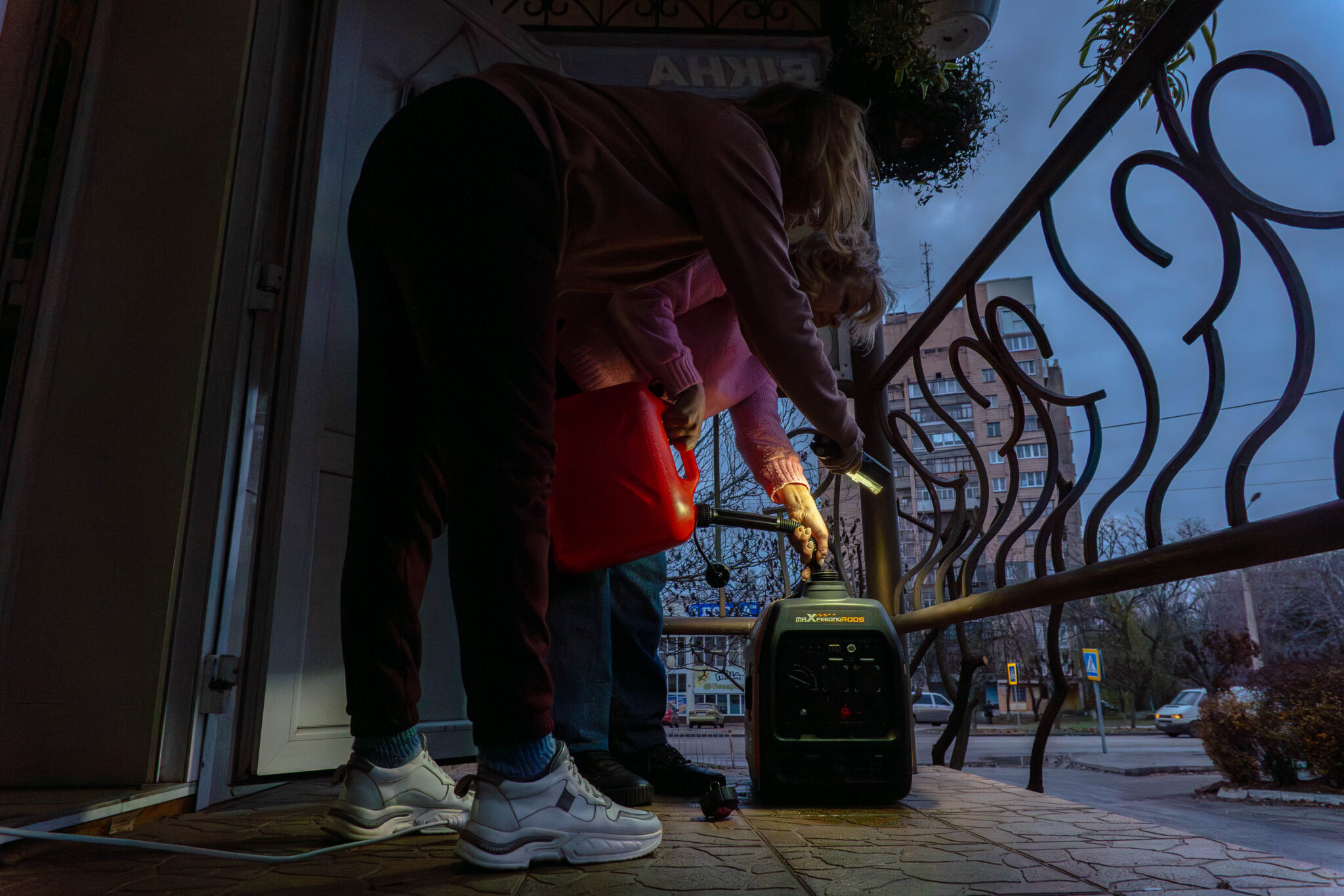 Shopkeepers starting their generator after a blackout started